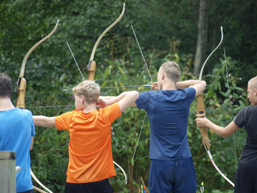 Groep geniet van buitenactiviteiten op een privé camping in de Belgische Ardennen.